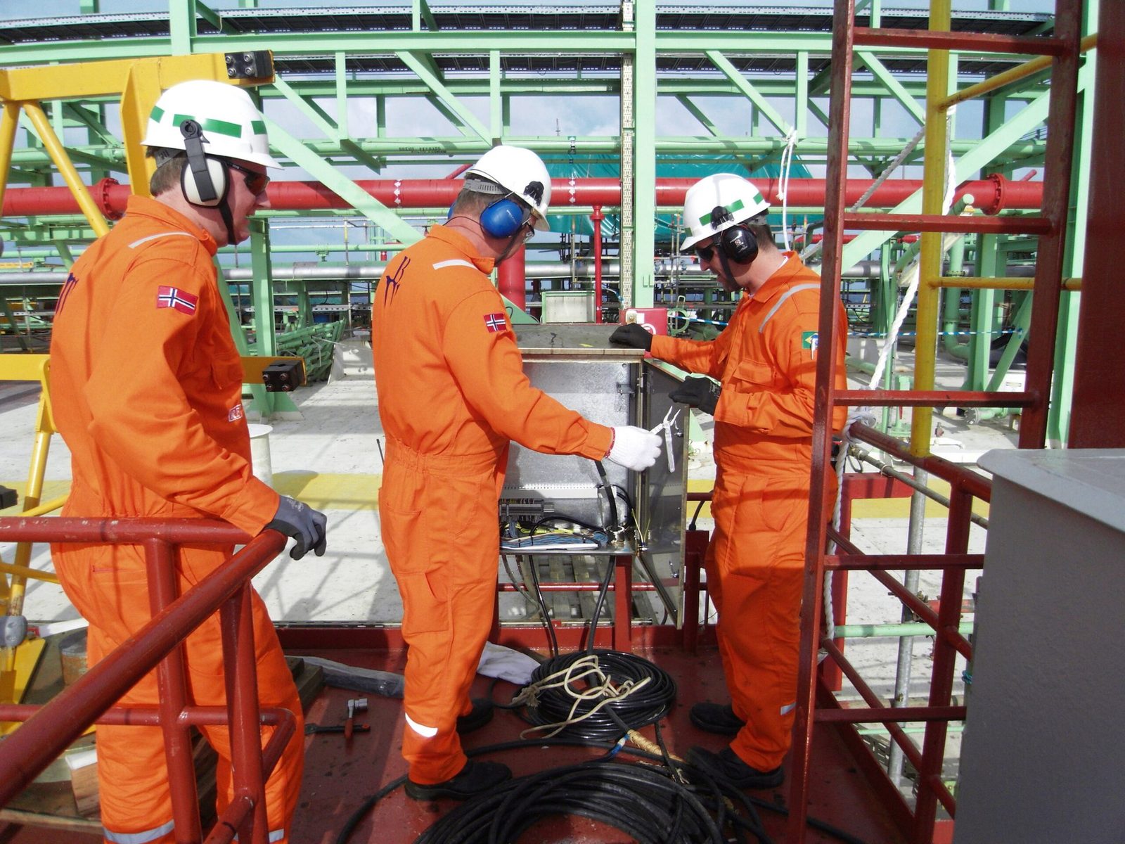 Service engineers working on a junction box offshore